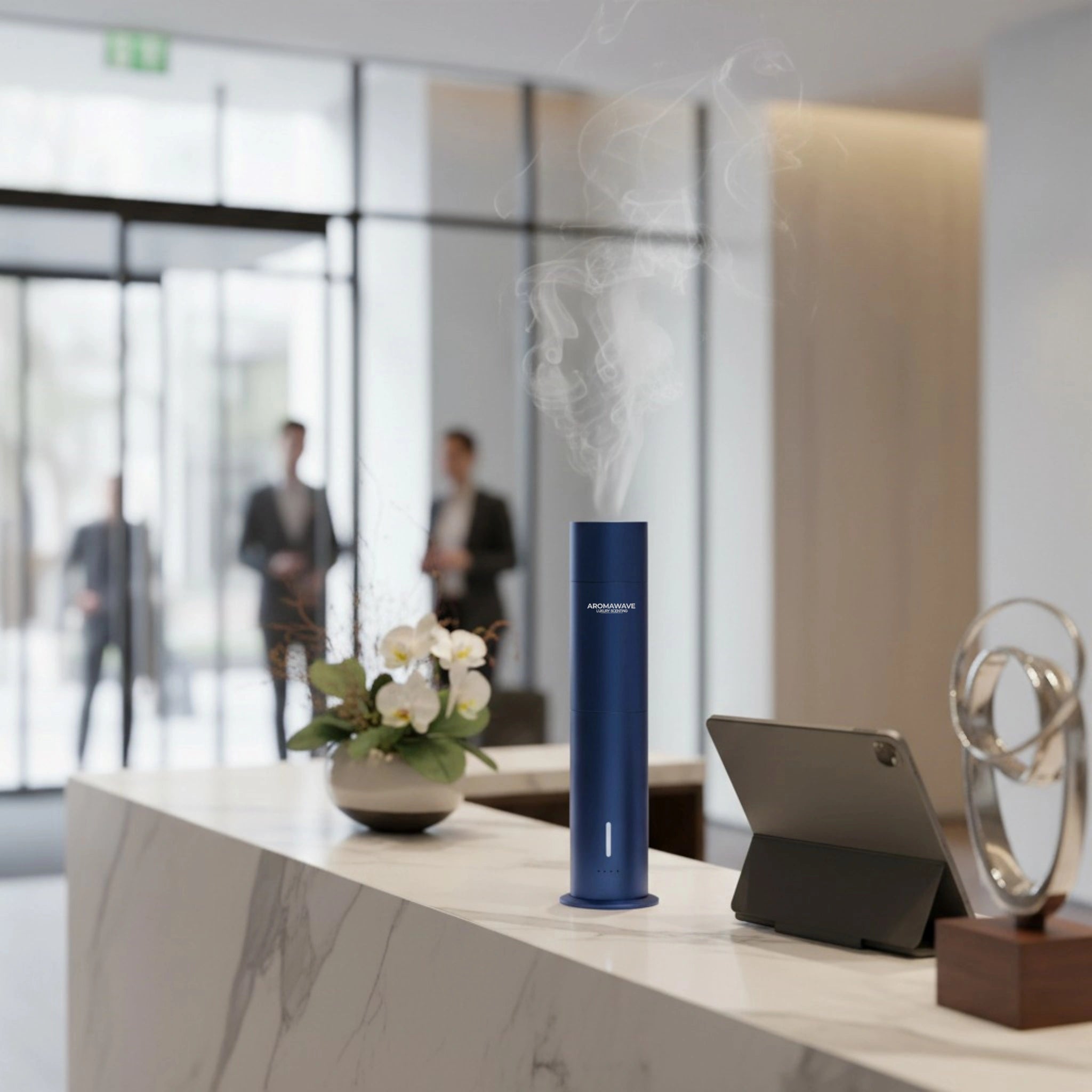 Wireless Ultra Smart scent diffuser in blue releasing gentle mist on a marble reception counter in a modern office lobby
